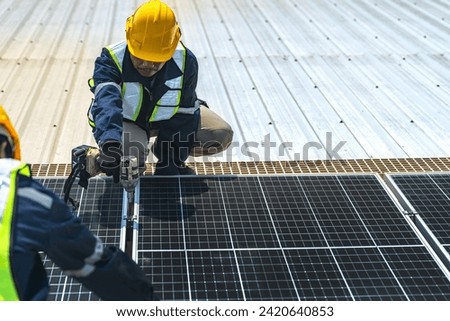 Worker Technicians are working to construct solar panels system on roof with sky and clound on background. Installing solar photovoltaic panel system. Renewable clean energy technology concept.