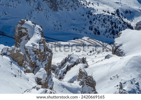 Ski resort in the Dolomites. Mountain recreation place. Ski slopes in the Dolomites on a clear sunny day. Alpine skiing sport and recreation. Royalty-Free Stock Photo #2420669165