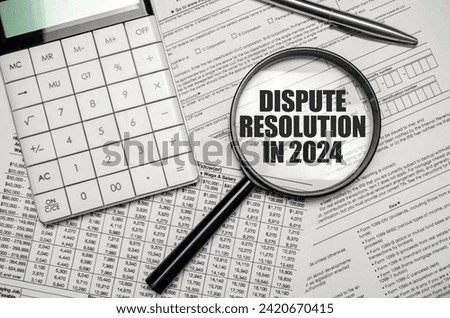 DISPUTE RESOLUTION IN 2024 word on magnifying glass with calculator and documents Royalty-Free Stock Photo #2420670415