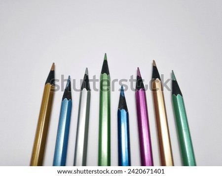 Colored wooden pencils on a white background. Close-up. Set of stationery
