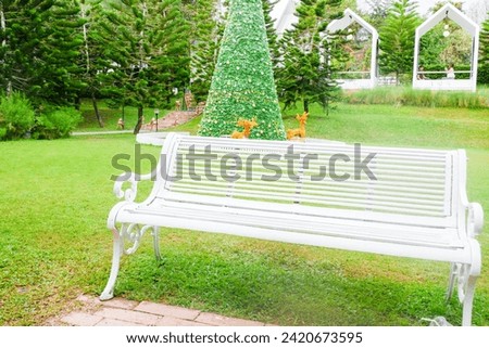 White Park Bench in a public Park,no people,garden concept.
