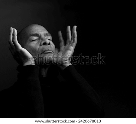 black man praying to god with people stock image stock photo