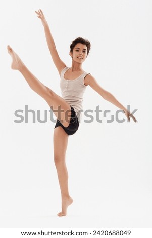 Dance, ballet and portrait of girl in studio for performance, fitness and training for theatre. Ballerina, young dancer and isolated person for balance, routine and practice on white background