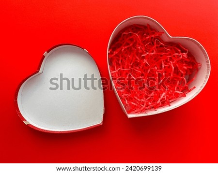 Top view of an open empty heart shaped box on a red background for your products. Happy Valentine's Day, happy women's day, mother's day, birthday. Royalty-Free Stock Photo #2420699139