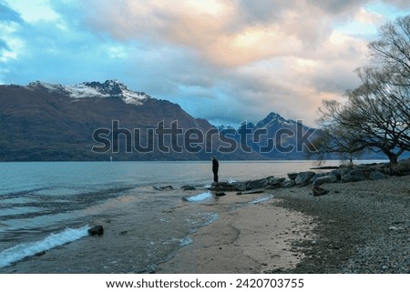 Person on the beach in Arrowtown, New Zealand, at dusk