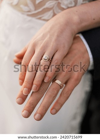 Bride and groom's hands with gold wedding rings Royalty-Free Stock Photo #2420715699