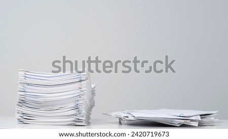 Time lapse of paper sheets on white background. Stop motion animation of one loaded stack with blanks and additional documents at the desk. Royalty-Free Stock Photo #2420719673