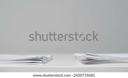 Time lapse of paper sheets on white background. Stop motion animation of blanks business documents laying at the desk.