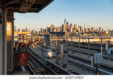 Sunrise over the New York City skyline and G Subway train