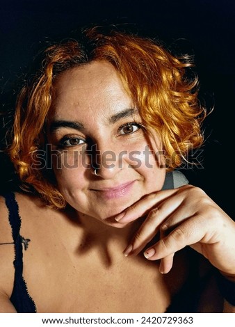 Young woman with copper-colored dyed hair, self photo, vertical photo.
