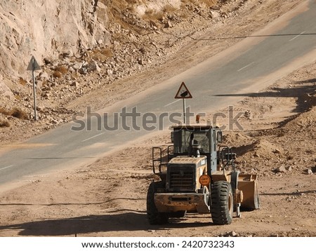 Heavy machinery on a desert road in Jordan.