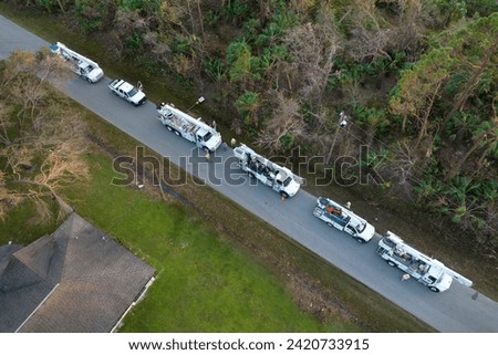 Aerial view of electrician workers repairing damaged power lines after hurricane in Florida suburban area Royalty-Free Stock Photo #2420733915