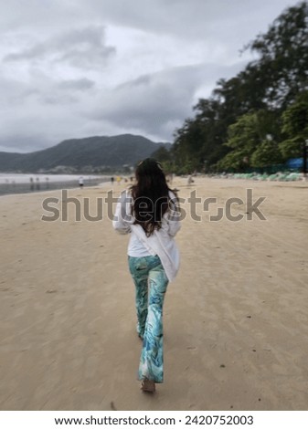 Beach picture single woman with mountain background 