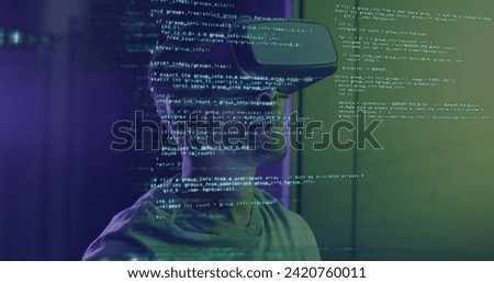Image of data processing over african american man working on laptop in server room. network, programming, computers and technology concept digitally generated image.