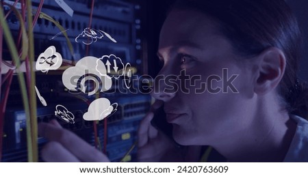 Image of globe with icons over caucasian woman working in server room. network, programming, computers and technology concept digitally generated image.