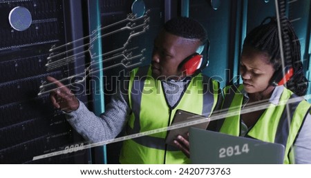Image of lines and numbers over african american man and woman working in server room. network, programming, computers and technology concept digitally generated image.