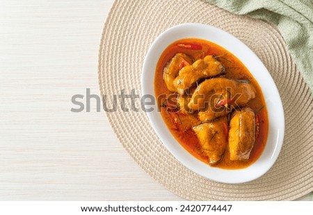 Redtail Catfish Fish in Dried Red Curry Sauce that called Choo Chee or a king of curry cooked with fish served with a spicy sauce Royalty-Free Stock Photo #2420774447