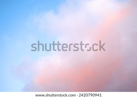Blue sky and pink cotton candy-like clouds.