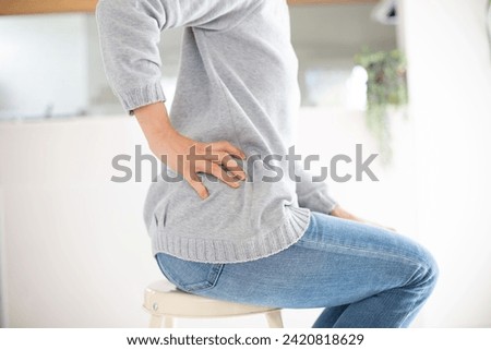 A middle-aged Japanese woman suffering from back pain Royalty-Free Stock Photo #2420818629