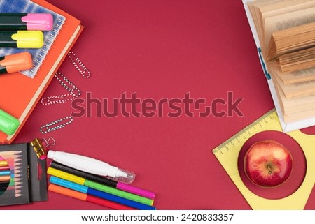 Back to school. Stationery on a Burgundy table. Office desk with copy space. Flat lay