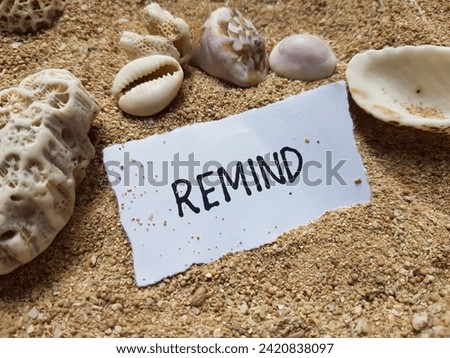 Remind writting on beach sand background.