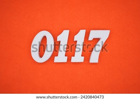 Orange felt is the background. The numbers 0117 are made from white painted wood.