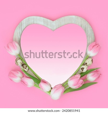 Tulip flower and quail egg abstract heart shape frame with gradient insert. Spring and Easter minimal floral nature food design on pastel pink background. Royalty-Free Stock Photo #2420851941
