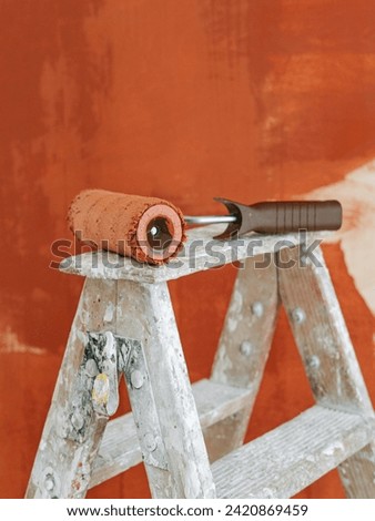 Paint whitewashing brushes wall orange color.