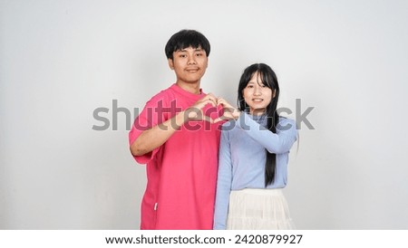 Photo of loving couple making heart symbol wearing casual clothes on isolated white color background         