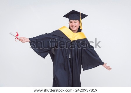 An upbeat and vivacious female graduate celebrating her diploma of bachelor of science. Feeling triumphant. Isolated on a white background. Royalty-Free Stock Photo #2420937819