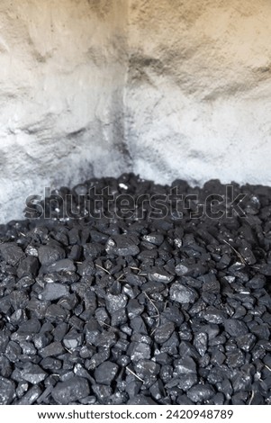 Coal is dumped in a coal warehouse Royalty-Free Stock Photo #2420948789