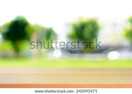 Wood table top on blurred green nature abstract background