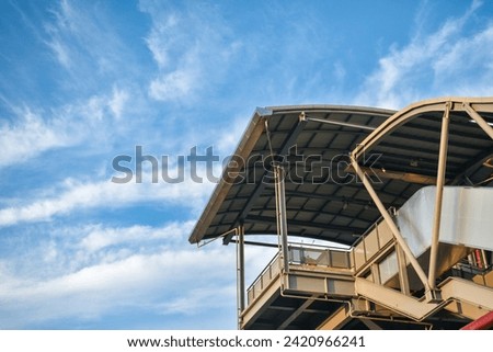 Entrance to a modern skytrain station in the capital Bangkok is Intercity public transportation on a beautiful blue sky background. Royalty-Free Stock Photo #2420966241