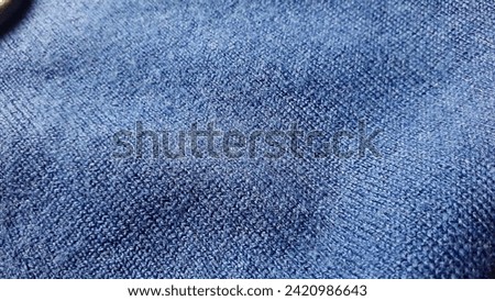 Dark blue cashmere. Dark wool natural fabric. Fabric texture. Knitwear.
