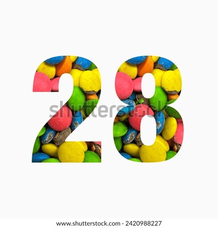 Number twenty eight of colourful candies and paper cut in shape of twenty eighth digit isolated on white. Rainbow typeface