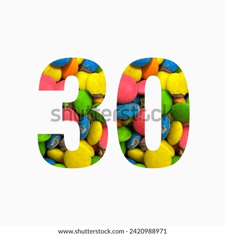 Number thirty of colourful candies and paper cut in shape of thirtieth digit isolated on white. Rainbow typeface