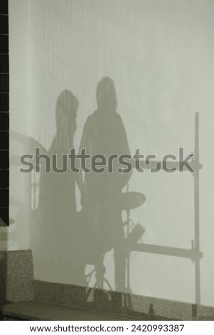 Musician shadows on white wall