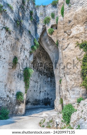 Entrance of the cave named Ear of Dionysius, one of the main landmarks in Neapolis Archaeological Park,  Syracuse, Sicily, Italy Royalty-Free Stock Photo #2420997135