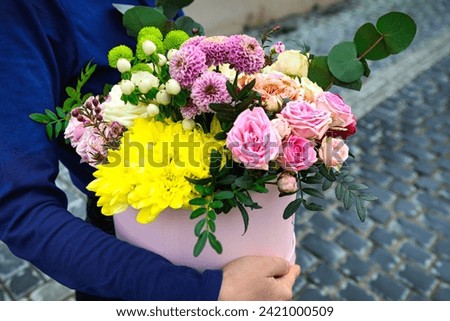 An image of a person holding a beautiful bouquet of flowers in their hands, with copy space.