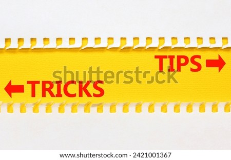 Tips and tricks symbol. Concept word Tips and tricks on beautiful yellow paper. Beautiful white paper background. Business and Tips and tricks concept. Copy space.
