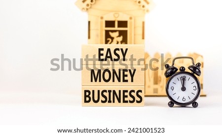 Easy money business symbol. Concept words Easy money business on beautiful wooden blocks. Beautiful white table white background. Black alarm clock. Easy money business concept. Copy space.