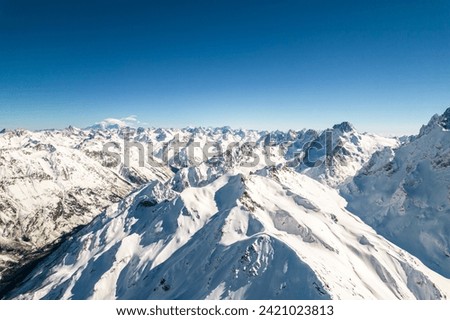 mountain rocky ridge with snow  Royalty-Free Stock Photo #2421023813