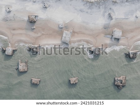 Aerial view captures the historical Vigsø Batteriet, Denmark. Coastal defense structures stand against the rugged shoreline, blending history with the natural beauty of the North Sea landscapes. Royalty-Free Stock Photo #2421031215
