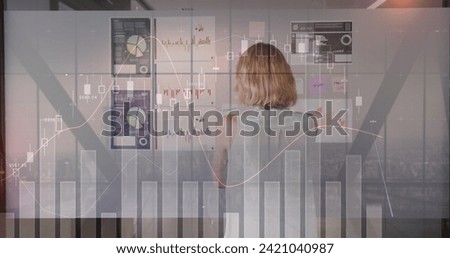 Image of interface showing information and statistics with businesswoman on phone in office. global communication technology digitally generated image.
