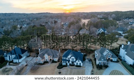 Aerial panoramic view of an upscale subdivision in suburbs of USA shot during golden hour in HDR