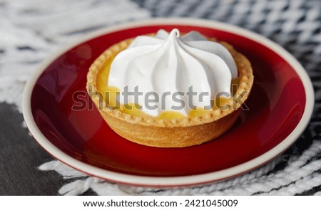 lemon tart with meringue cream on a saucer