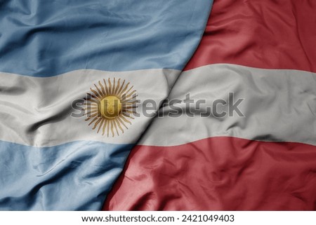 big waving national colorful flag of austria and national flag of argentina . macro