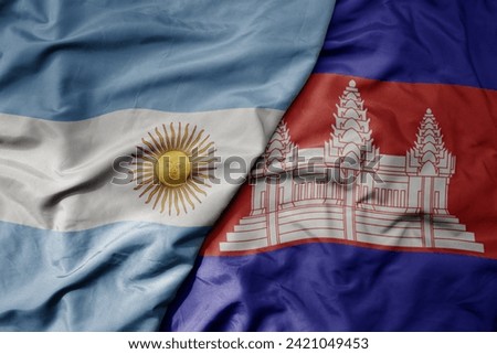 big waving national colorful flag of cambodia and national flag of argentina . macro