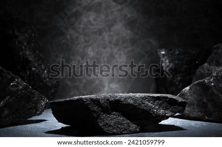 granite stones for the podium. black natural stones with texture on a dark background for a minimalist podium for the presentation of a product: cosmetics, medicine, perfumery, body care, jewelry