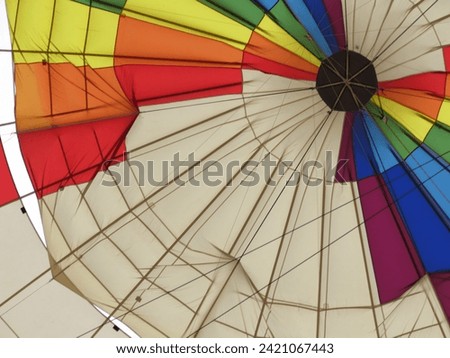 This is how you land in the balloon, it is released like a hatch in the canvas, the air escapes and you lose height, great skill of the pilots, a very fragile trip Royalty-Free Stock Photo #2421067443